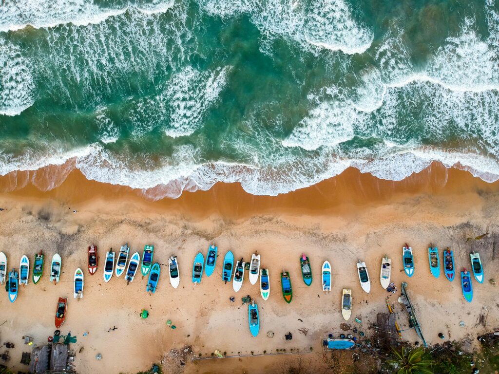 a sandy beach with turquoise waves crashing along the shoreline
