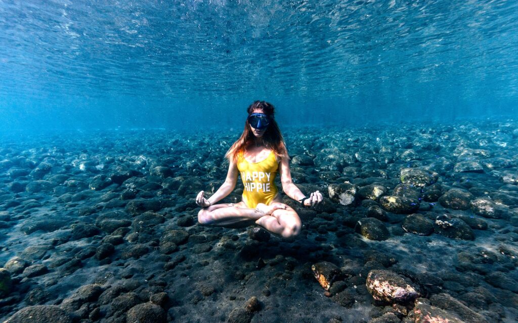 Traveler exploring vibrant coral reefs during a diving trip in Bali, Indonesia, surrounded by tropical marine life and clear blue waters