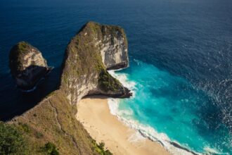 Aerial view of a beautiful Bali beach during dry season with clear turquoise water and white sand