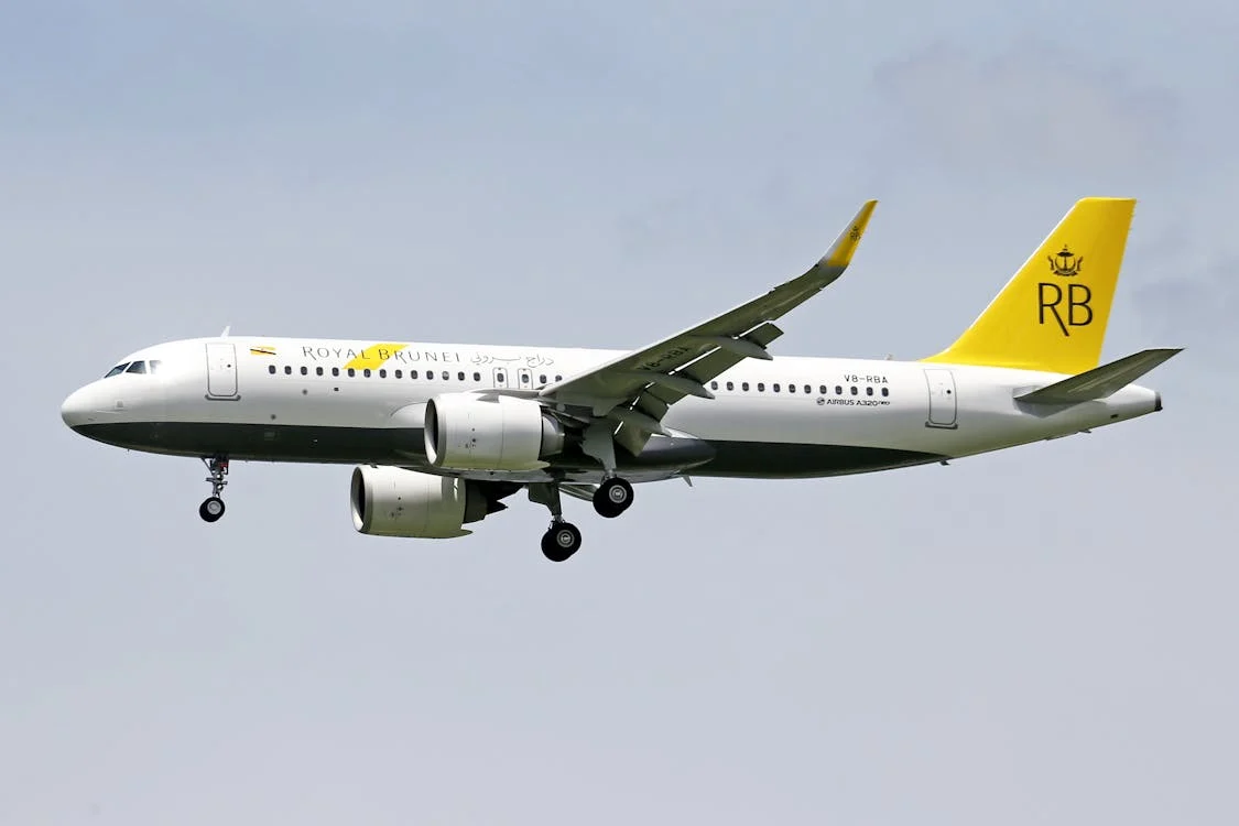 Máy bay của Royal Brunei bay qua bầu trời trong xanh với những đám mây nhỏ ở phía sau
