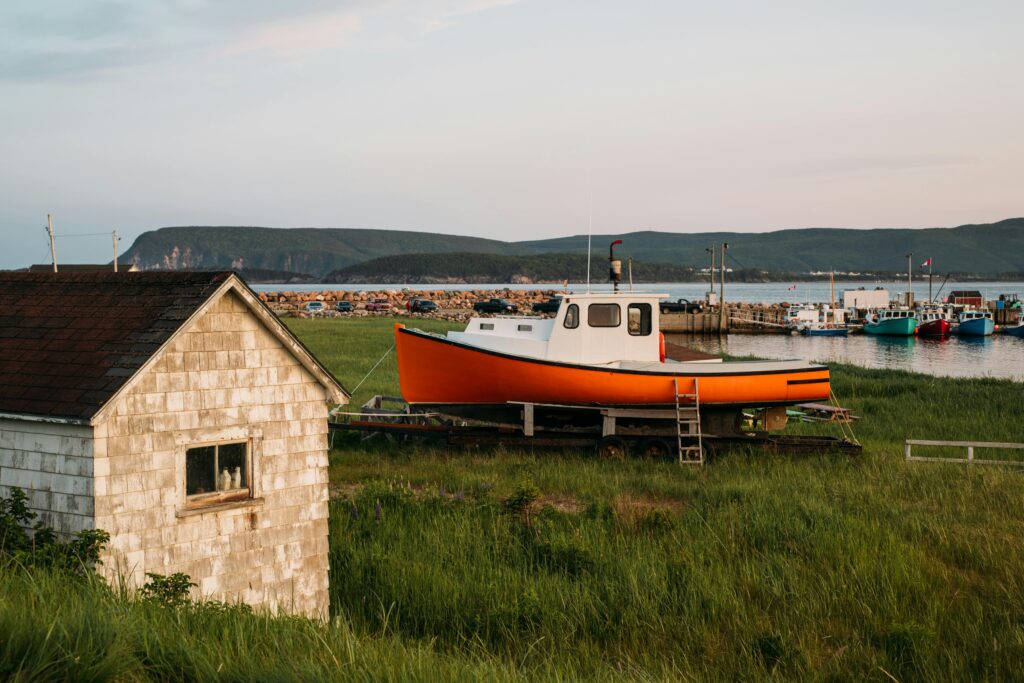 Colorful fishing boats docked at a scenic harbor on Cape Breton Island, Canada,