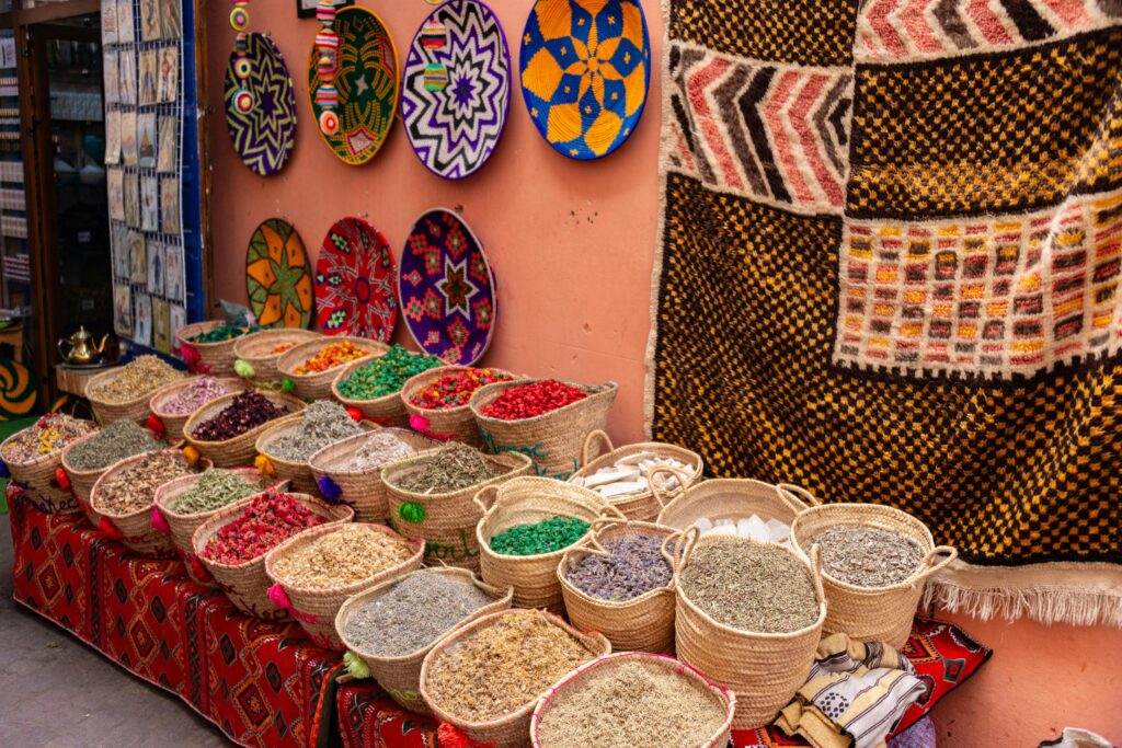 Colorful Moroccan market stalls with solo traveler examining handcrafted goods during first solo trip to Africa