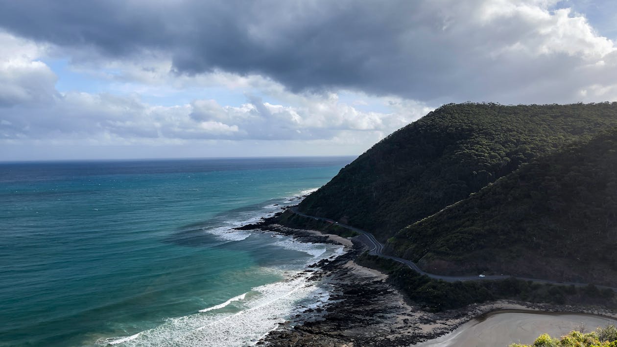 Great Ocean Road with majestic coastal cliffs, deep blue sea, and a clear horizon stretching into the distance