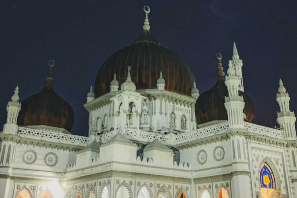 Kapitan Keling Mosque in George Town, Penang, featuring its iconic domed roof under a starry night sky.