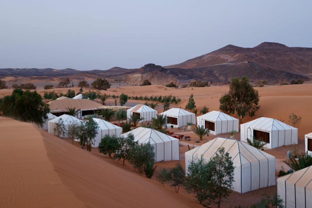 Luxury safari tent overlooking waterhole where animals gather during first solo trip to Africa"