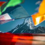 Majestic Himalayan peaks with colorful prayer flags - best places to visit in Nepal