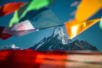 Majestic Himalayan peaks with colorful prayer flags - best places to visit in Nepal