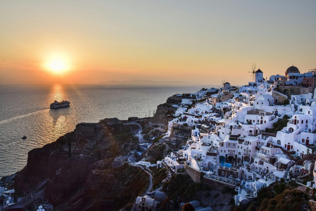 image-santorini-sunsetthtaking sunset view over Santorini's white buildings and blue domes