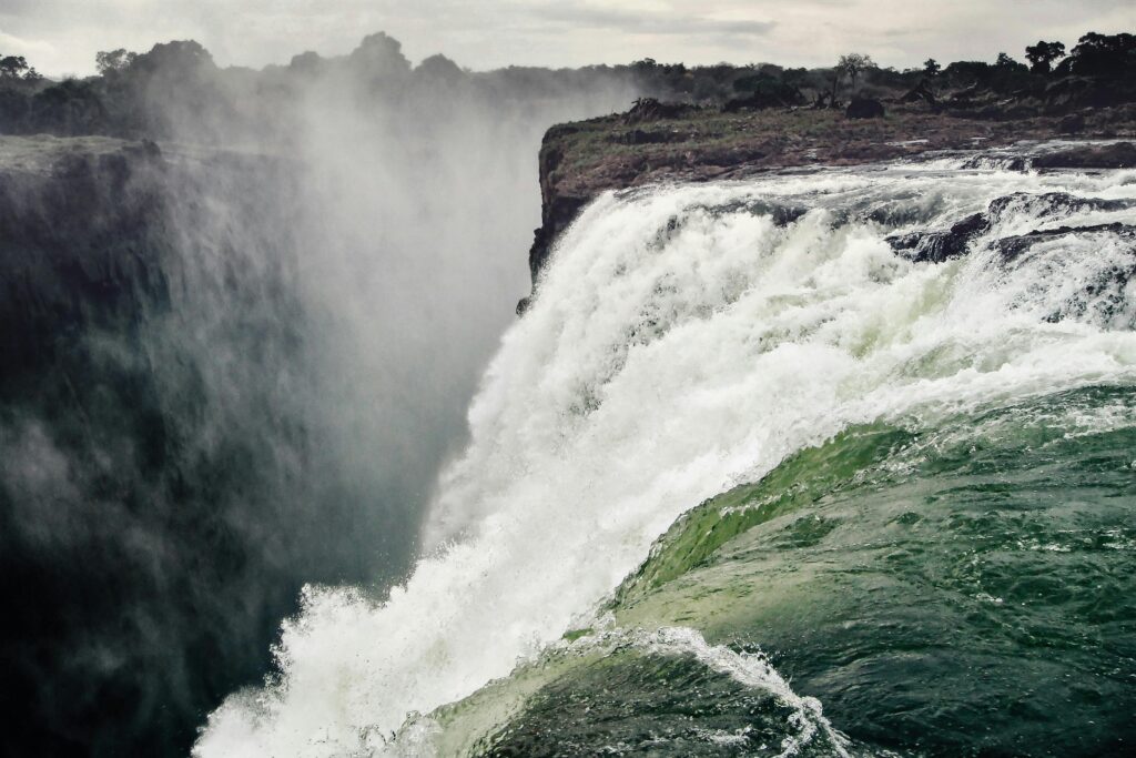 solo female traveler photographing Victoria Falls during first solo trip to Africa