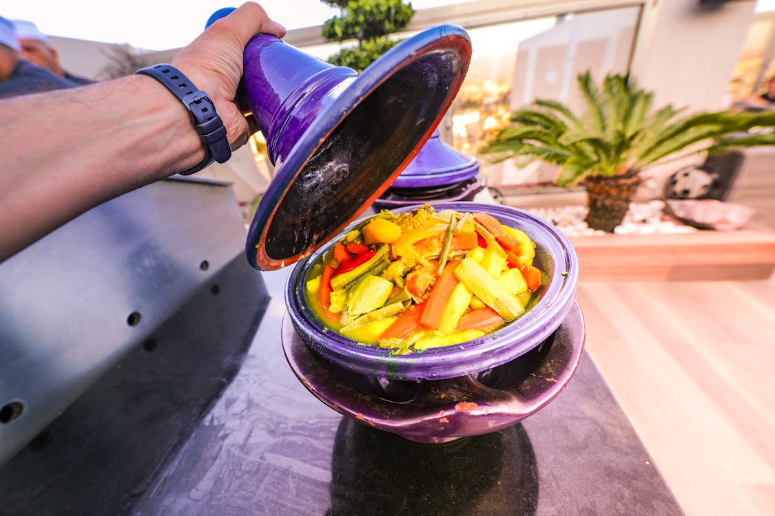 Traditional Moroccan tagine cooking, representing the best local foods to try in Morocco