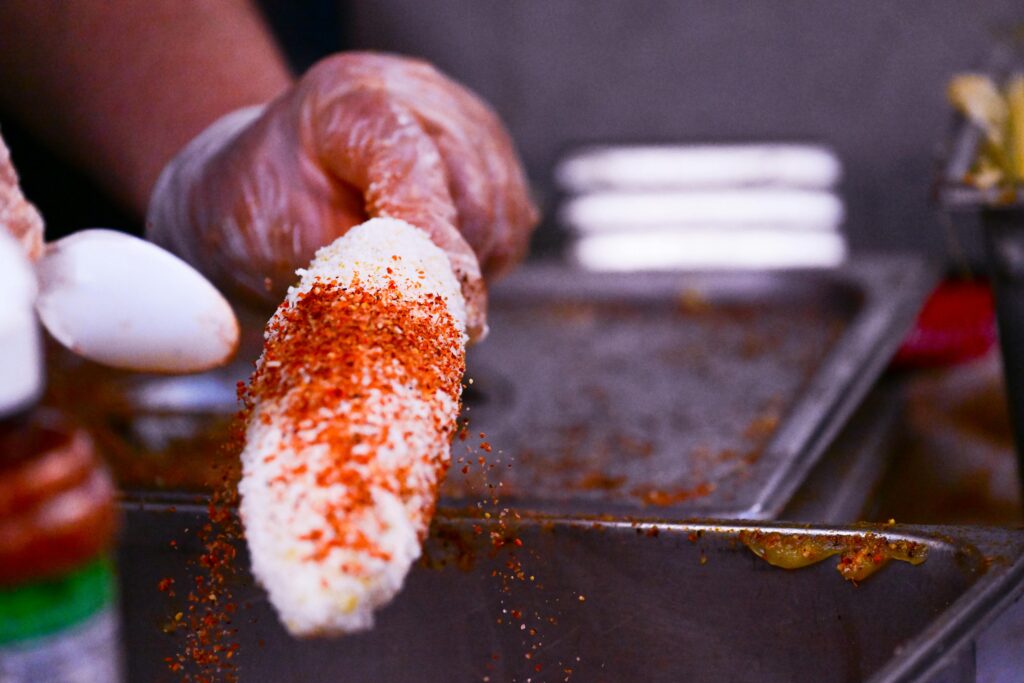 Mexican street food elotes with traditional toppings - authentic Mexican food