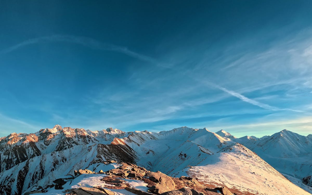 Snow-covered Tien Shan mountains in Almaty Region during winter, showcasing dramatic peaks and frosty alpine landscapes