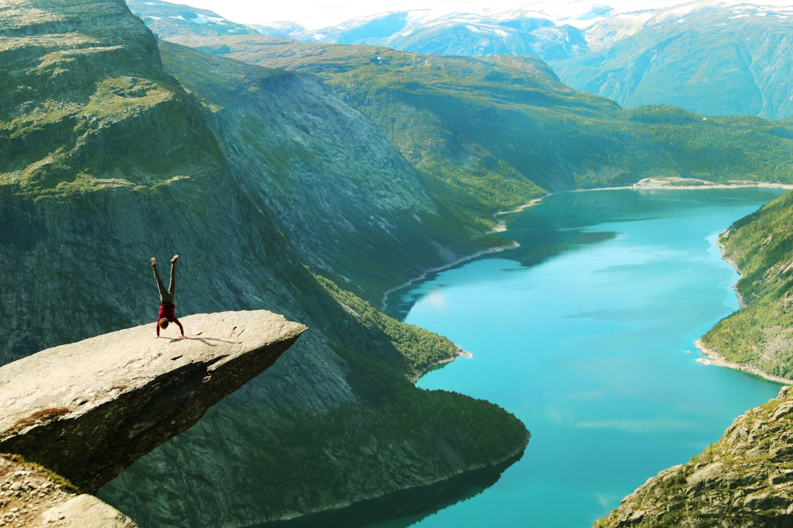 Best places to visit in Norway - Trolltunga's dramatic rock formation over lake