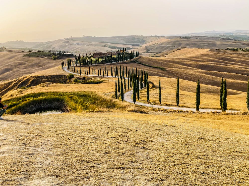 Vehicle at sunset viewpoint during a European road trip through Tuscany