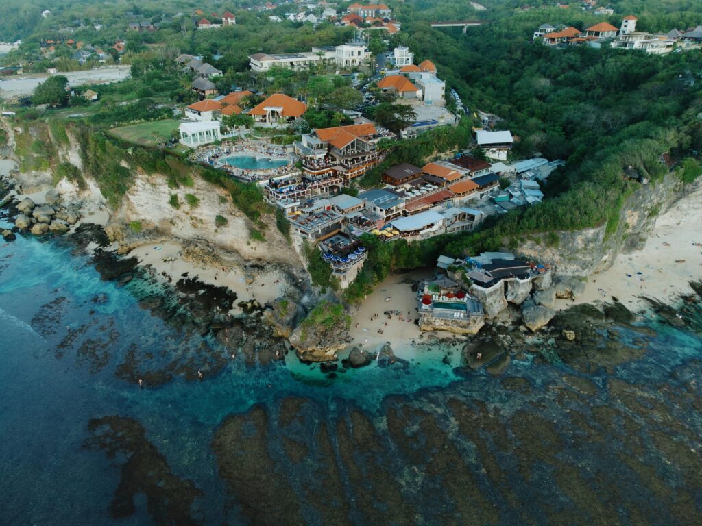 Cliffside luxury resort overlooking the ocean in Uluwatu, Bali, featuring infinity pools, elegant villas, and breathtaking sunset views
