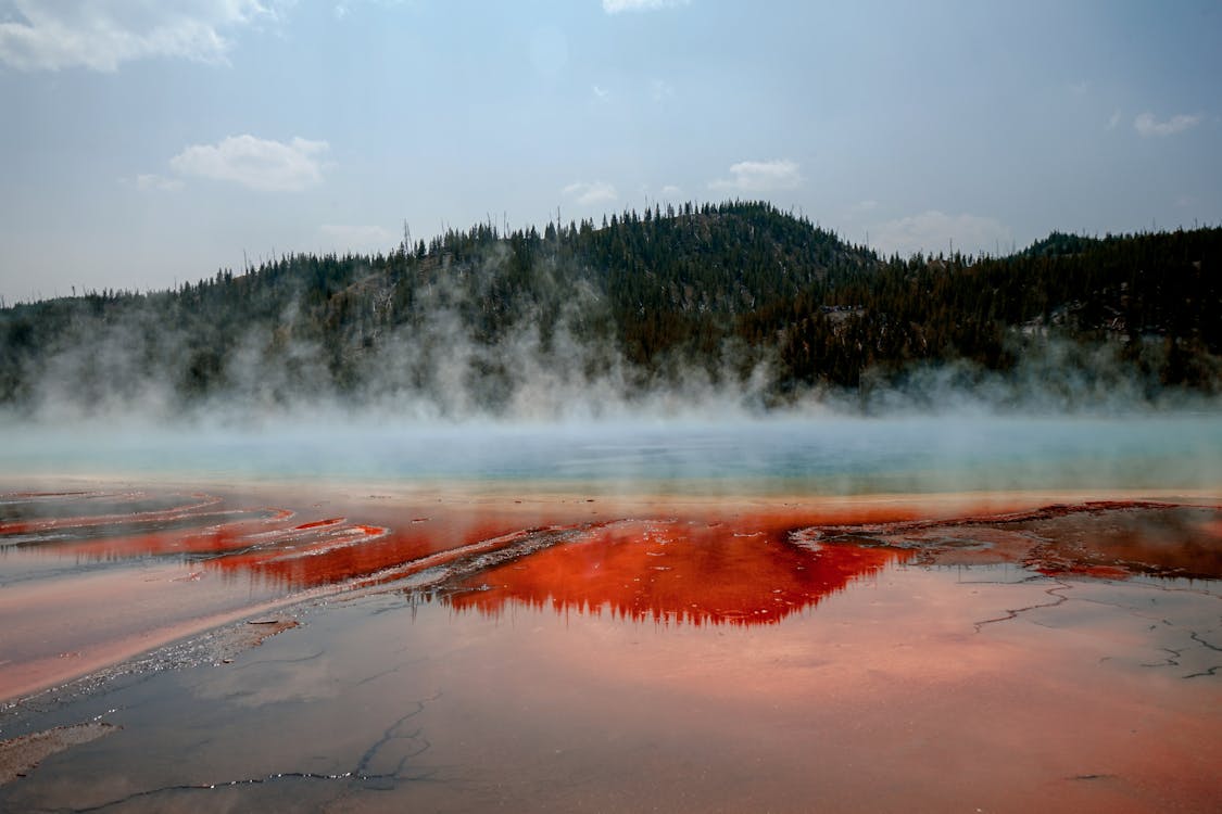 A stunning view of Yellowstone National Park with geothermal features, hot springs