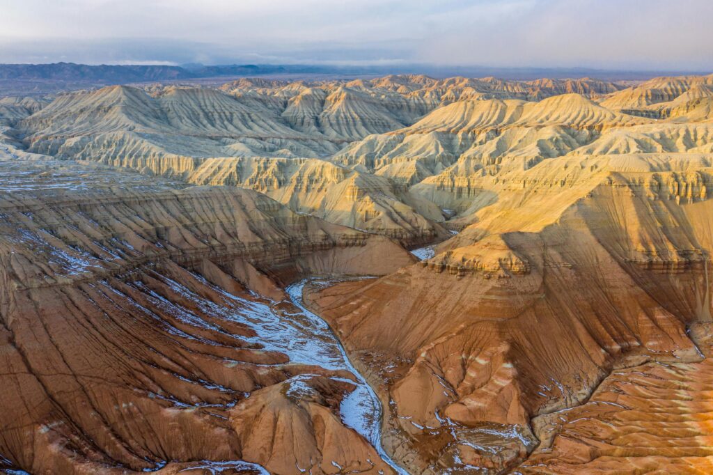 Aerial view of colorful layered rock formations in Aktau Mountains, Altyn-Emel National Park, Kazakhstan
