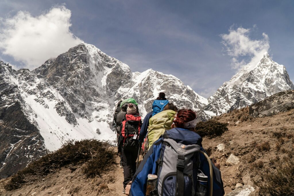 Hiker trekking in the Himalayas with snow-capped peaks in the background