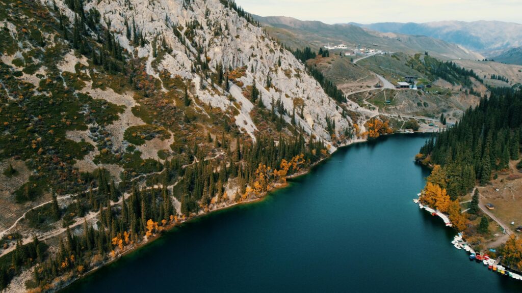 Lake Kaindy surrounded by forested mountains in Almaty Region, Kazakhstan, known for its submerged trees and scenic beauty