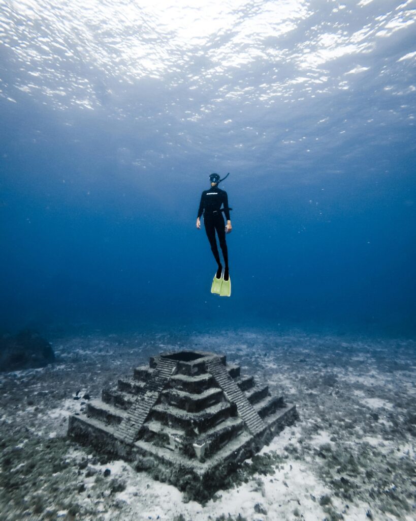 Scuba diving and snorkeling in the Yucatán Peninsula with vibrant coral reefs, crystal-clear cenotes, and marine life in Mexico