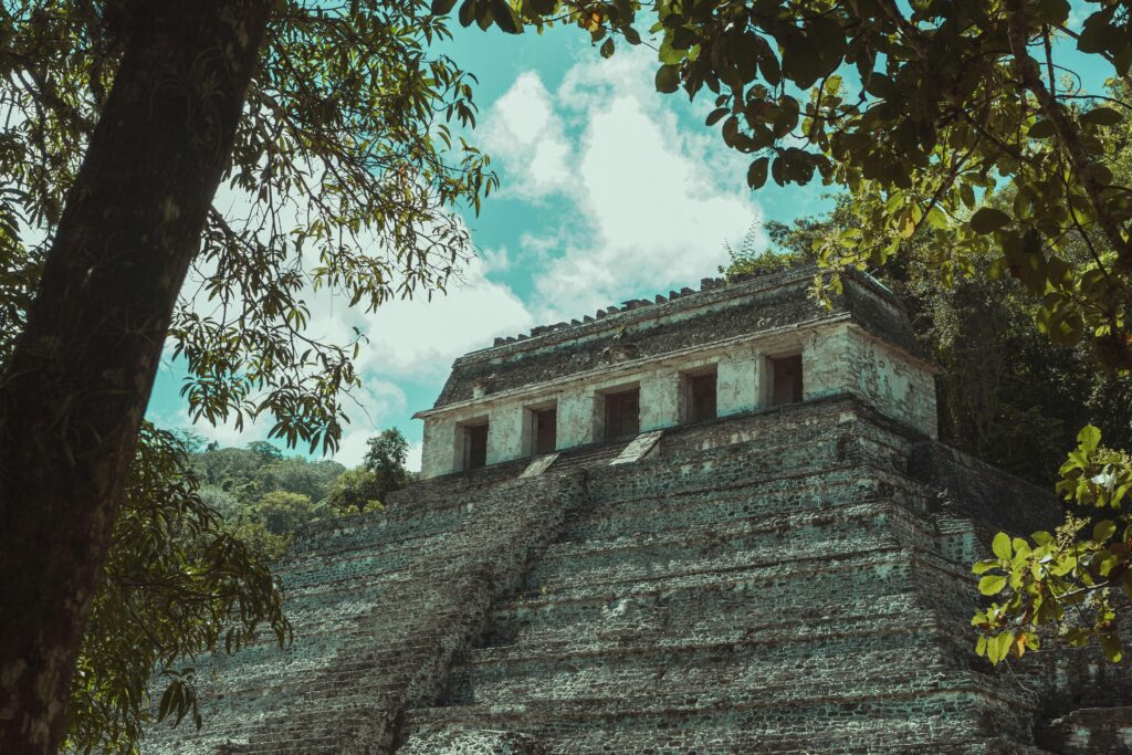 Ancient Mayan temple ruins surrounded by tropical jungle in Mexico