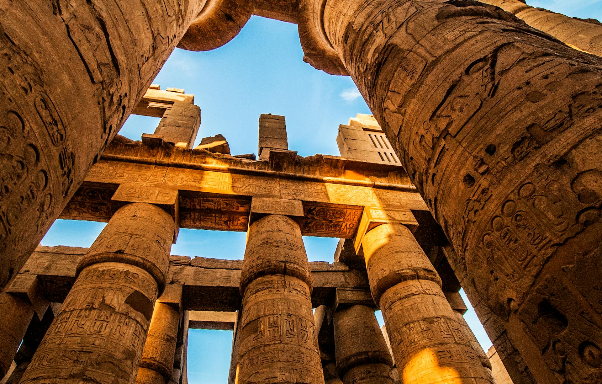 Ancient columns of Karnak Temple in Luxor, Egypt under golden morning light