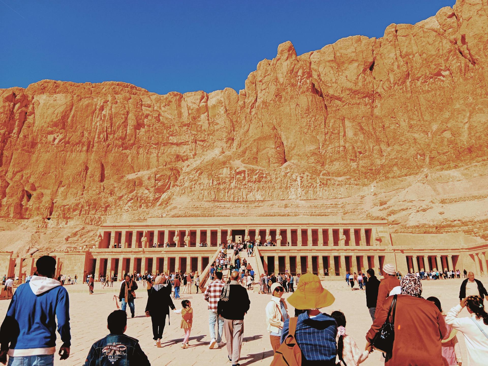 Is it safe to travel to Egypt in 2025? Tourists exploring the Temple of Hatshepsut in Luxor, one of the safest and most visited sites."