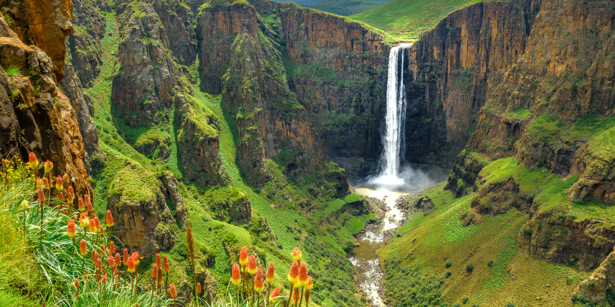 A panoramic view of Lesotho's highland valleys and rugged green mountains.
